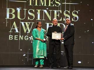 Dr. Anju Majeed(Left) & Shaheen Majeed(Right) receiving the Times Business Awards Lifetime Achievement Award from Indian actor and director Anupam Kher(Center)